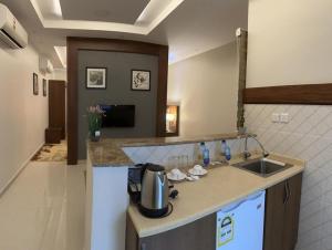 a kitchen with a sink and a counter top at Delta Hotel Suites in Jazan