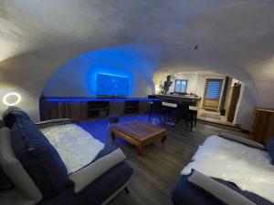 a living room with a couch and a piano at Maison Stabatio Appartement Pierre in Le Monêtier-les-Bains