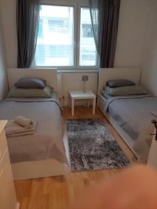 a bedroom with two beds and a window at 3-rooms apartment for up to 4 persons near to Prater in Vienna