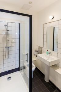 a bathroom with a shower and a sink and a toilet at The Bristol Wing in Bristol