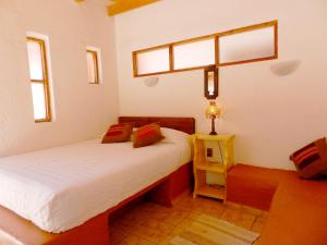 Cama o camas de una habitación en Hostal Sumaj