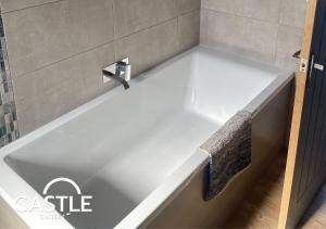 a white bath tub with a faucet in a bathroom at Ultimate Retreat 2 houses 2 Hot Tubs Double Fun in Cayton