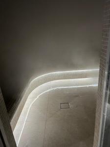 a bathroom with a bath tub with a tile floor at Apartament Angel City SPA Silownia in Wrocław