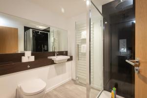 a bathroom with a toilet and a sink and a shower at Luxury Apartment with Garden, and Putting Green in St. Andrews