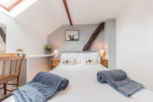 um quarto com uma cama com duas toalhas em Byre Cottage Woodland Coniston em Torver