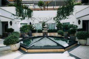 a glass pool in the courtyard of a building at BLESS Hotel Madrid - The Leading Hotels of the World in Madrid