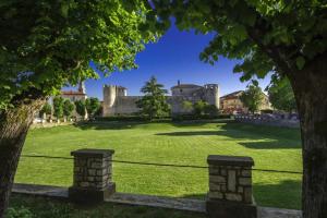 a castle in the middle of a green field at Apartment Elena, village Peresiji in Peresiji