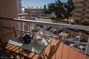 a table on a balcony with a view of a city at Beach Studio in Benalmádena