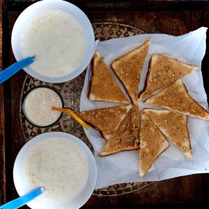 a table with two cups of dip and some crackers at Peacock Paying Guest House in Udaipur