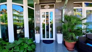 a front door of a building with potted plants at Laguna in Kiten