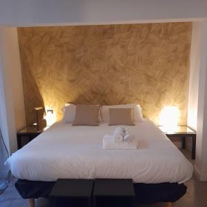 a bedroom with a large bed with two towels on it at loft farnese 2 in Rome