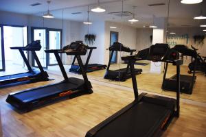 a gym with several tread machines in a room at La Serena Mar, Benalmadena Pueblo, Luxury Apartment with Jacuzzi in Benalmádena