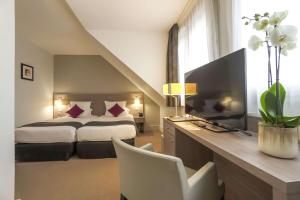 Postelja oz. postelje v sobi nastanitve Best Western Plus Hotel Du Parc Chantilly