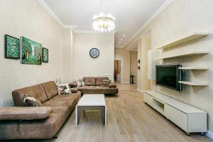 a living room with a couch and a tv at Luxury House in Nizami Street in Baku