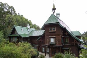 a large wooden house with a green roof at Villa Schönthaler in Semmering