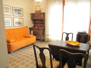 a living room with an orange couch and a table at Breathtaking seaview in Grado-Beahost Rentals in Lido