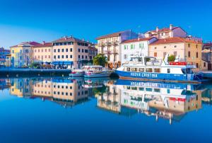 a group of boats docked in a harbor with buildings at Breathtaking seaview in Grado-Beahost Rentals in Lido