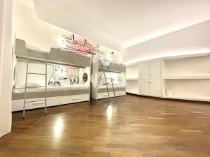 バーリにあるBARI ROOMS Abate Gimmaの二段ベッド2台と棚が備わる広い客室です。