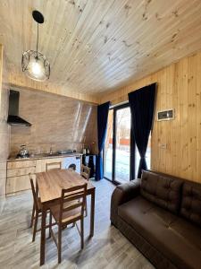un soggiorno con un tavolo e un divano di Cottage Orcs a Borjomi