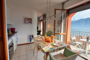 a dining room with a table and a view of the ocean at Lake View Apartment Golden Triangle in Acquaseria