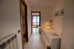 a small room with two beds and a hallway at Lake View Apartment Golden Triangle in Acquaseria
