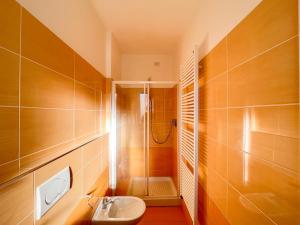 a bathroom with a shower and a toilet and a sink at Homiday - Residence K2 in Pineto