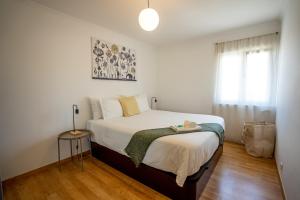 a bedroom with a bed and a window at Olivais Apartment River View in Lisbon