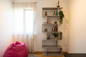 a room with a book shelf and a window at Olivais Apartment River View in Lisbon