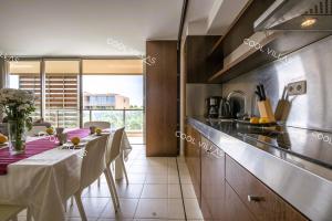 a kitchen with a table and a dining room at Apartamento Chocolate - 300 meters from Salgados beach in Guia