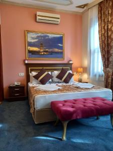 a bedroom with a large bed with a red wall at Emirhan Hotel & Sultanahmet in Istanbul