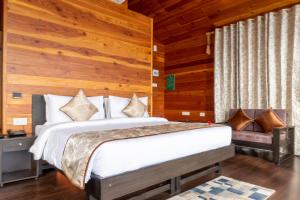 a bedroom with a bed with wooden walls and wooden floors at Le ROI Floating Huts & Eco Rooms Tehri in Tehri-Garhwāl