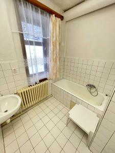 a bathroom with a tub and a sink and a bath tub at Zlatá vyhlídka in Benecko