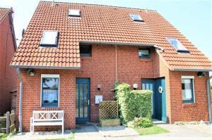 a red brick house with an orange roof at Haus Kamp in Dahme