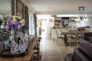 a living room with a table with flowers on it at Laverockbank Farmhouse in Perth +24 photos