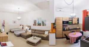 a living room with a couch and a table at Apartments Pia in Subotica