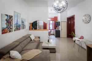 a living room with a couch and a table at Apartments Pia in Subotica
