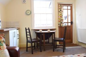 a kitchen with a table and chairs and a window at Top Flat in Lincoln