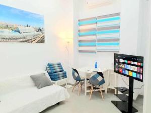 a bedroom with a bed and a table with chairs at Vivienda Turistica Valencia A3 in Valencia