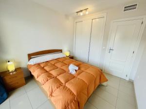 a bedroom with a bed with an orange blanket at A344 - Gemelos 24 - 2004 Finestrat s.l. in Villajoyosa