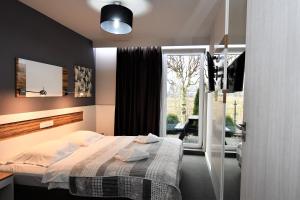 Ένα ή περισσότερα κρεβάτια σε δωμάτιο στο Sleepinn Gdansk Airport