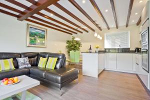 a living room with a couch and a table at Forge Bridge Cottage Coniston in Coniston
