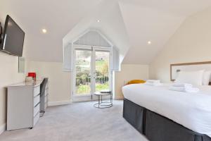 a bedroom with a large bed and a window at Forge Bridge Cottage Coniston in Coniston