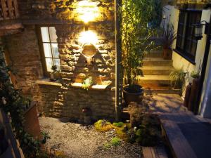 a stone house with a light on the side of it at Unique space in heart of Frome in Frome