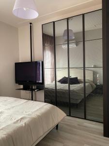 a bedroom with a bed and a television in it at Marco Polo Flat in Viareggio