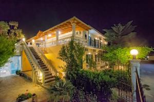 a house with stairs and plants at night at Kapetanios Boutique in Agios Georgios
