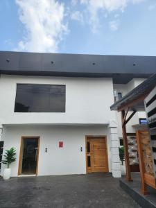 a white house with two doors and a porch at LUXOL HOMES&SUITES in Ikeja