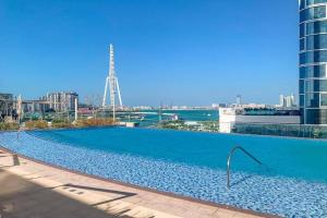 a large swimming pool on the roof of a building at Stylish 1 Bedroom in 5242 by Ofex in Dubai