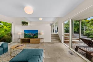 a living room with a couch and a tv at Spacious home with ocean views in Dromana