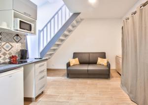 a living room with a couch and a staircase at 203.Mezzanine#4Pers#Malakoff in Malakoff