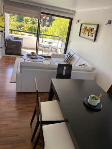 a living room with a couch and a table at Departamento Pucón in Pucón
